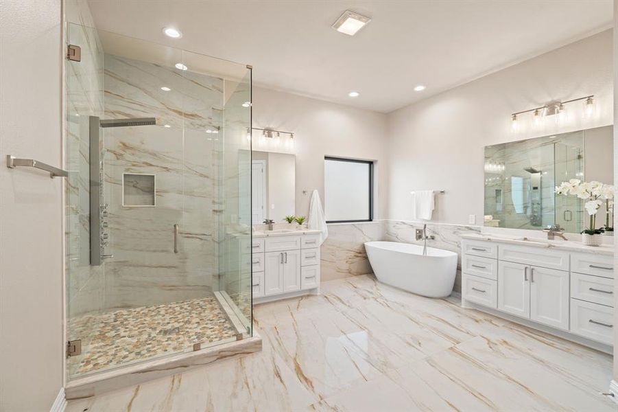 Bathroom with vanity and shower with separate bathtub