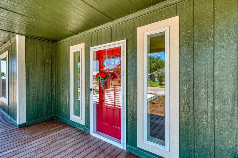 Vibrant red door creates a warm welcome on this home's inviting front porch. Vibrant red door creates a warm welcome on this home's inviting front porch.