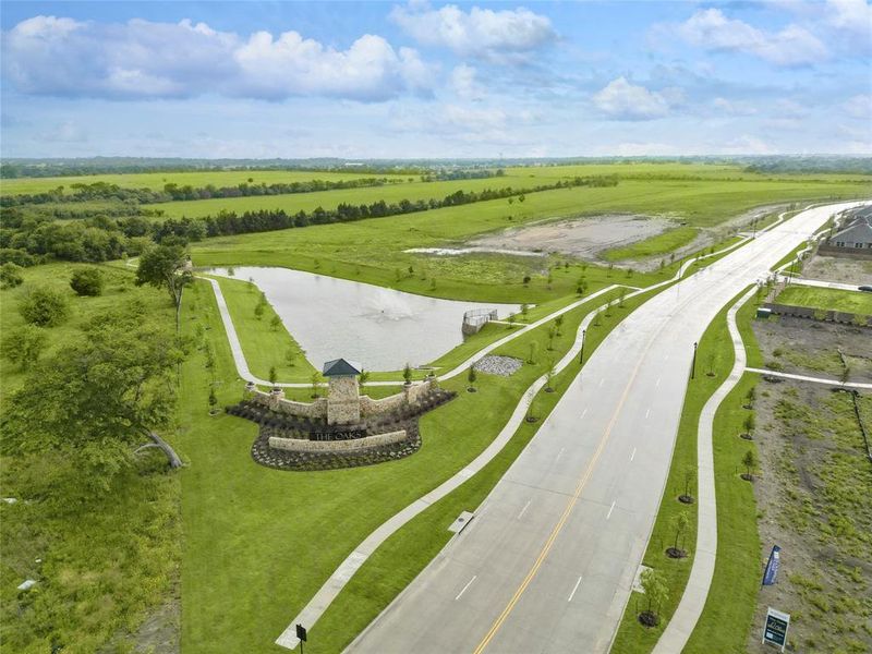 Drone / aerial view with a water view and a rural view