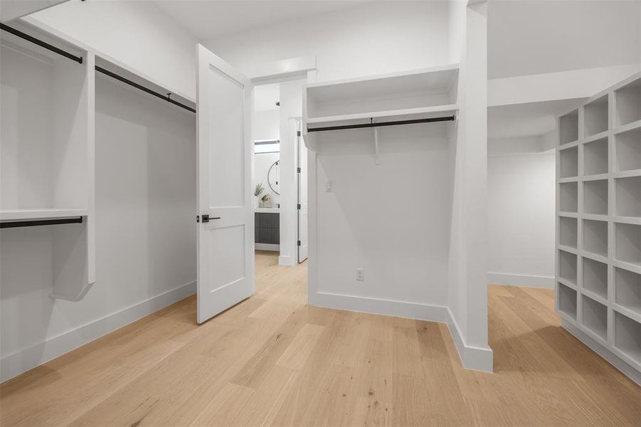 Ample storage solutions abound in this well-appointed walk-in closet, offering both hanging space and built-in shelving.