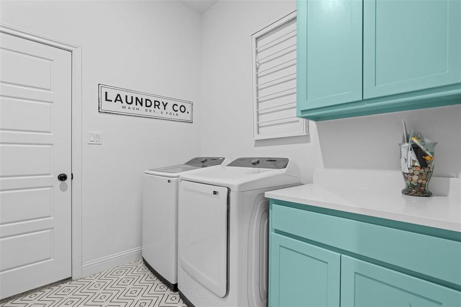 Washroom with cabinets and separate washer and dryer