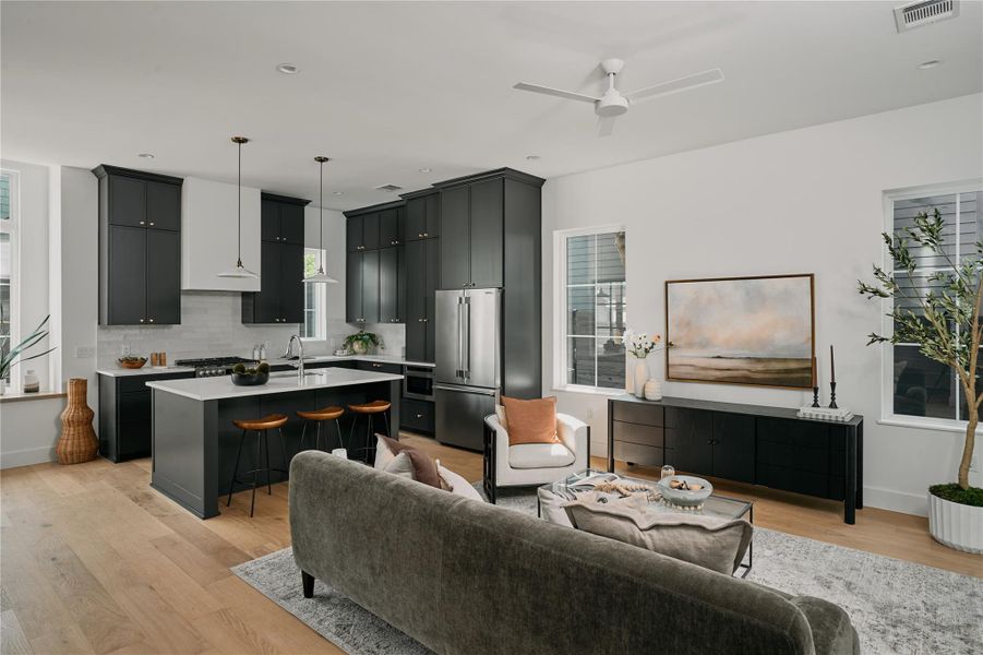 Living area featuring light wood finished floors, a ceiling fan, baseboards, and recessed lighting Living area featuring light wood finished floors, a ceiling fan, baseboards, and recessed lighting