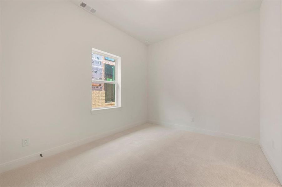 Neutral-toned carpeting and light-colored walls define this room