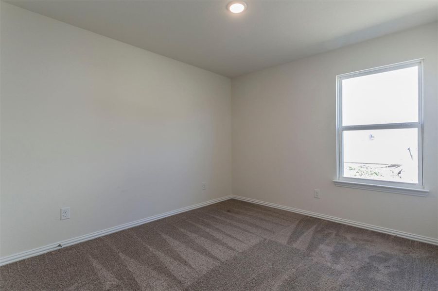 Empty room featuring baseboards and carpet Empty room featuring baseboards and carpet