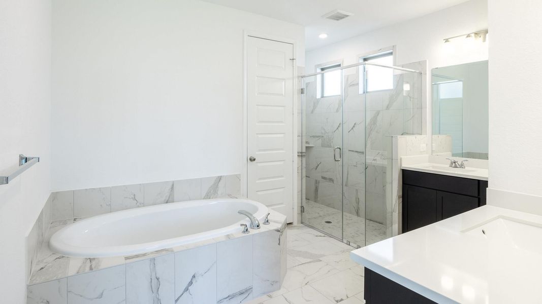 Full bathroom with vanity, a marble finish shower, a bath, and marble finish floors Full bathroom with vanity, a marble finish shower, a bath, and marble finish floors