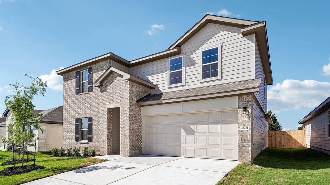 Front exterior of a new home in Carillon, Manor, TX, highlighting curb appeal (Image 17). Front exterior of a new home in Carillon, Manor, TX, highlighting curb appeal (Image 17).