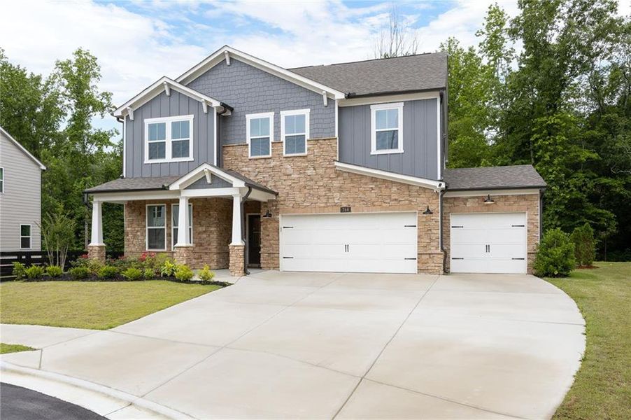 Front exterior of a new home in Hillside Manor, Powder Springs, GA, highlighting curb appeal (Image 26). Front exterior of a new home in Hillside Manor, Powder Springs, GA, highlighting curb appeal (Image 26).