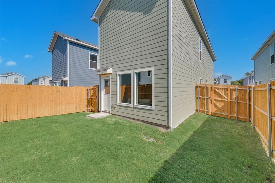 Rear view of property featuring a lawn