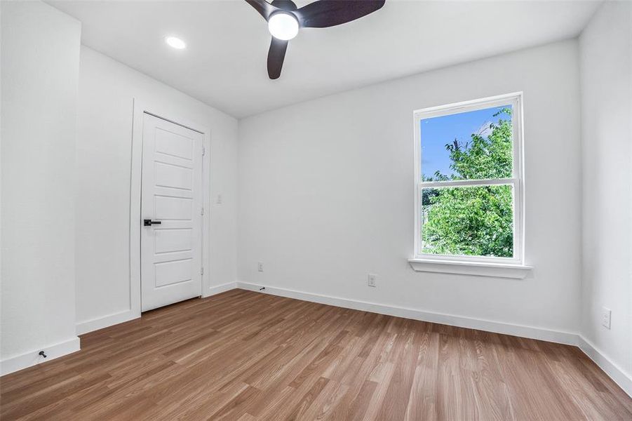 Empty room featuring light wood-style floors, ceiling fan, and recessed lighting Empty room featuring light wood-style floors, ceiling fan, and recessed lighting