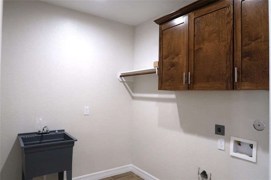 Walk in pantry/ mudroom with a utility sink.