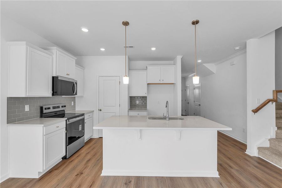 This bright kitchen features an island, ample cabi