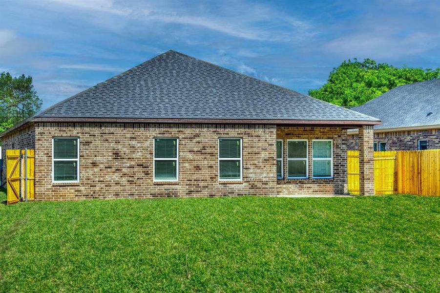 Rear view of house with a lawn