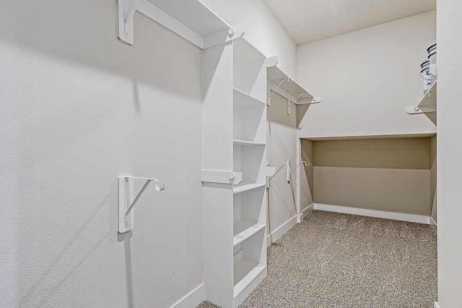 An oversized walk-in closet offers generous built-in shelving and hanging space, along with a tucked-away nook in the back—ideal for storing luggage, off-season items, or your hidden stash of Amazon boxes. An oversized walk-in closet offers generous built-in shelving and hanging space, along with a tucked-away nook in the back—ideal for storing luggage, off-season items, or your hidden stash of Amazon boxes.