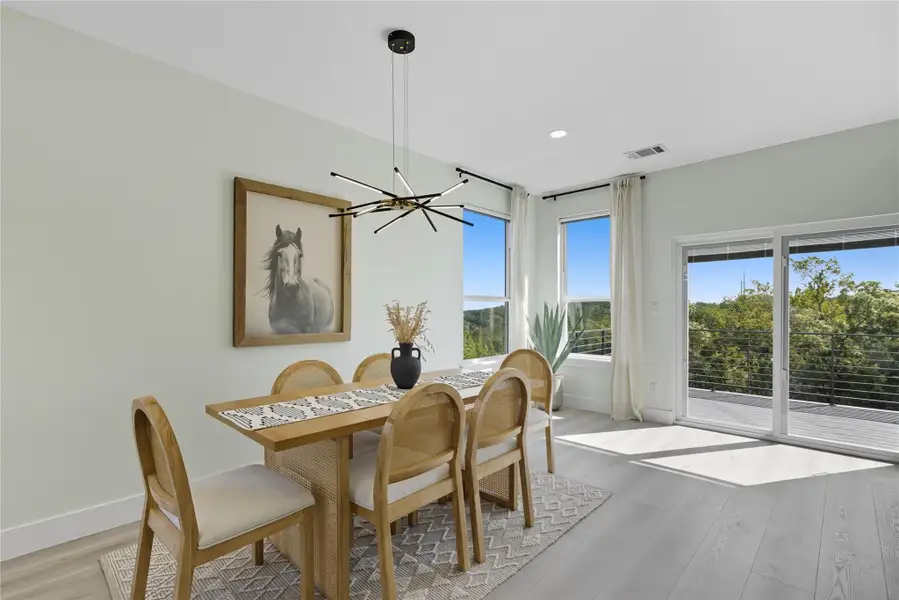 Dining area featuring wood finished floors, recessed lighting, and a chandelier