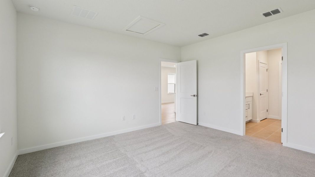 Naples First Floor Primary Suite with en suite bath with large walk-in closet at Grasslands West in Lakeland FL