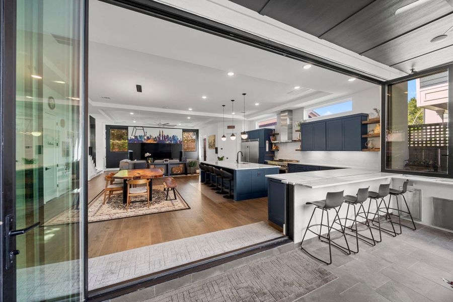 Summer kitchen leads seamlessly to open downstairs living.