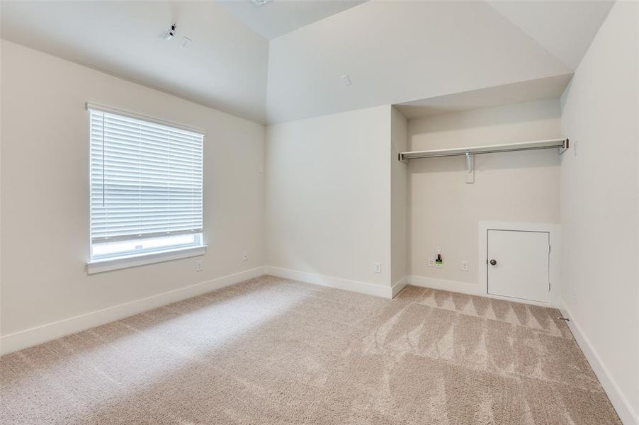 Washroom featuring light colored carpet and baseboards Washroom featuring light colored carpet and baseboards