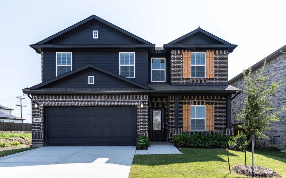 Front exterior of a new home in Travis Ranch, Forney, TX, highlighting curb appeal (Image 1). Front exterior of a new home in Travis Ranch, Forney, TX, highlighting curb appeal (Image 1).