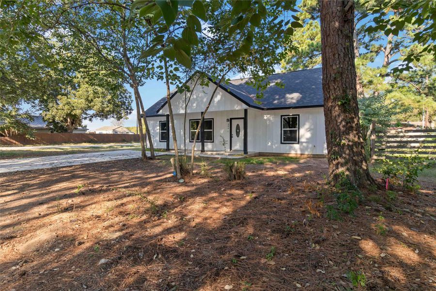 View of front of property featuring a porch and roof with shingles