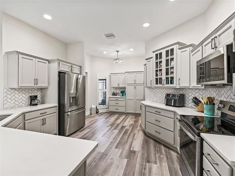 Kitchen with quartz counter tops and Marble backsplash in herringbone pattern