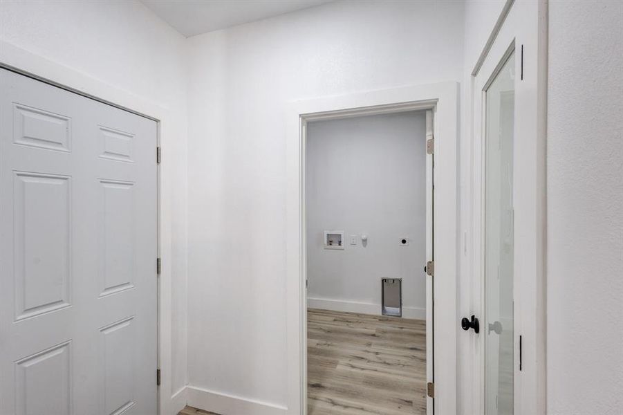 Corridor with light hardwood / wood-style floors