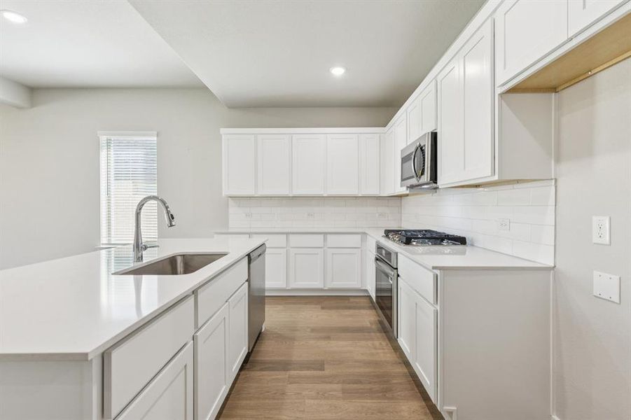 Kitchen in the Stanley II home plan by Trophy Signature Homes – REPRESENTATIVE PHOTO