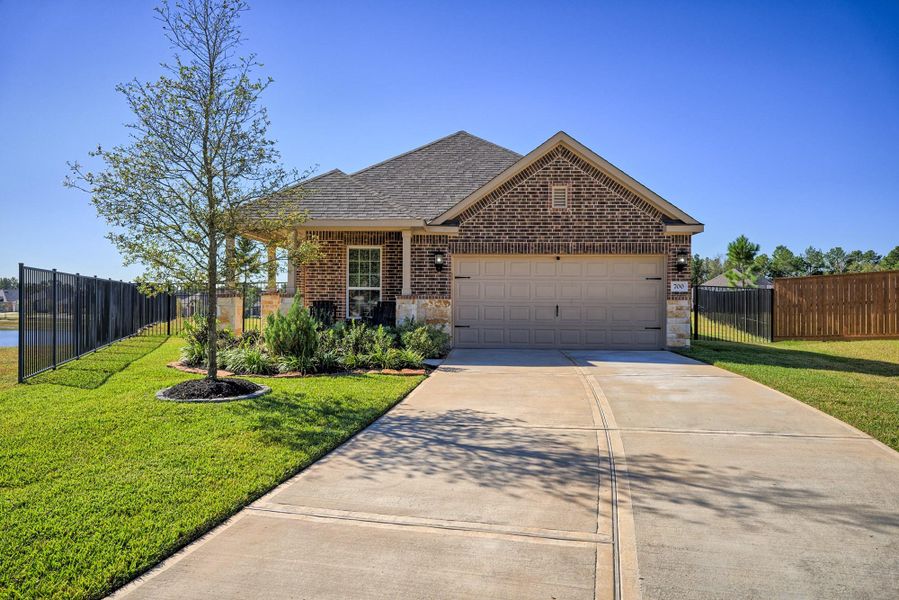 Front exterior of a new home in Wedgewood Forest, Conroe, TX, highlighting curb appeal (Image 1). Front exterior of a new home in Wedgewood Forest, Conroe, TX, highlighting curb appeal (Image 1).