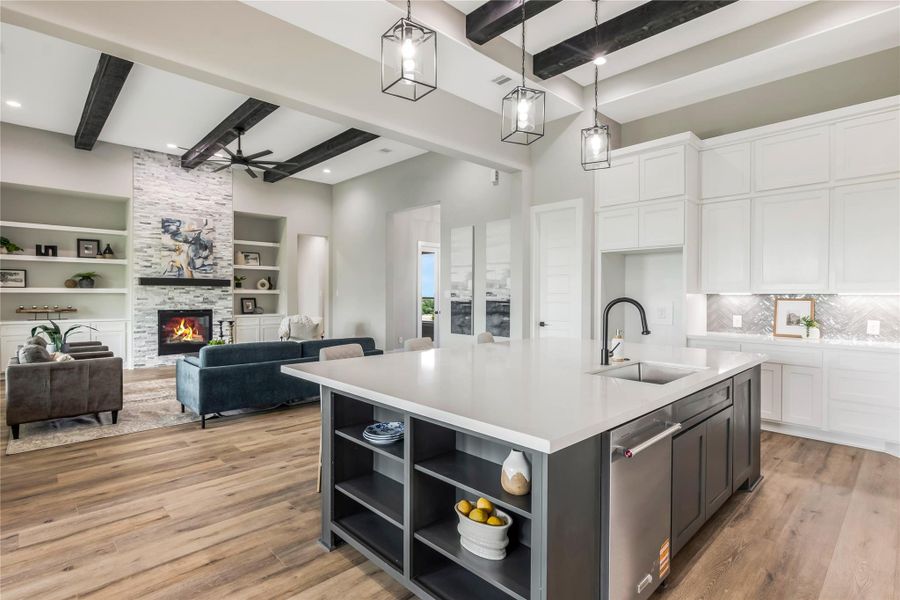 This open-concept living area flows from kitchen to the adjacent living room This open-concept living area flows from kitchen to the adjacent living room