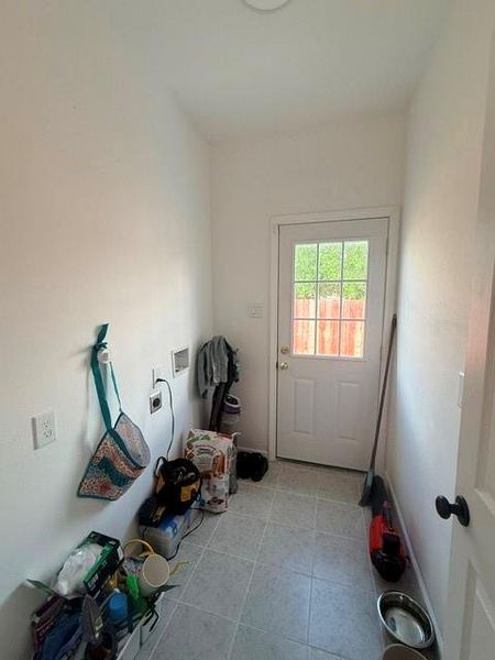 This photo shows a utility area and a back door with a window.