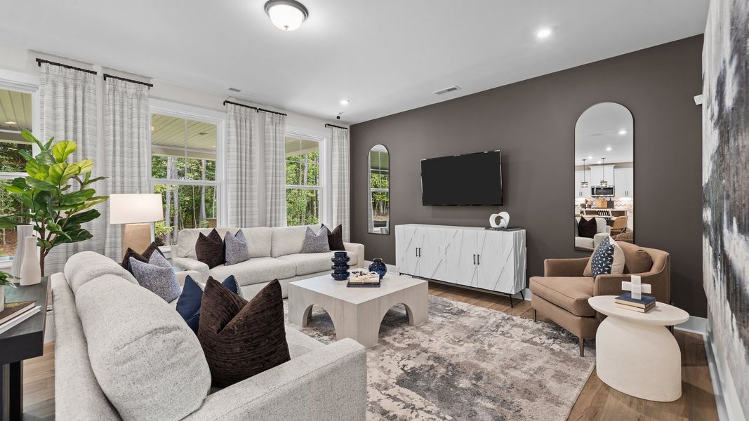 Cozy Family room with elevated ceiling and large windows in the Jordan Design by DRB Homes in York, SC