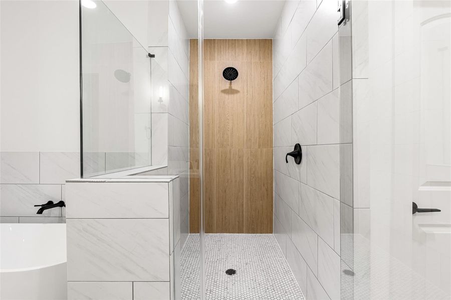 Luxurious walk-in shower featuring sleek white tiles, a stylish wood accent wall, and a built-in niche for conveniently storing your essentials. Luxurious walk-in shower featuring sleek white tiles, a stylish wood accent wall, and a built-in niche for conveniently storing your essentials.