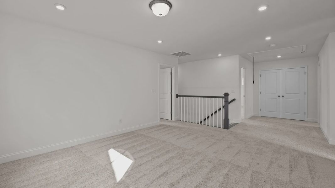 Burton Design ample and flexible loft space. At Lakeside Glen by DRB Homes in York, SC.