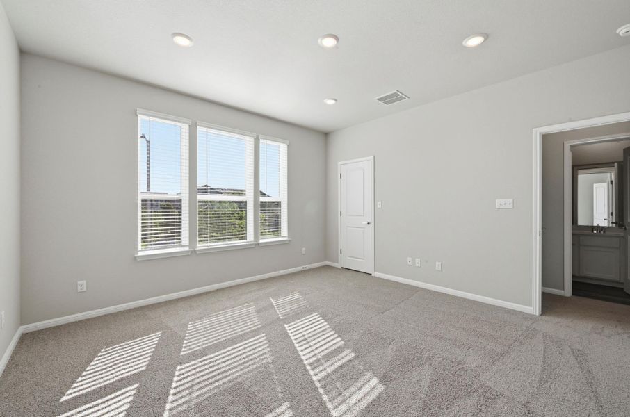 Spacious room featuring light gray walls, plush gray carpeting, and recessed ceiling lighting Spacious room featuring light gray walls, plush gray carpeting, and recessed ceiling lighting