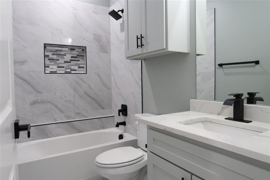 Full bathroom featuring vanity and washtub / shower combination