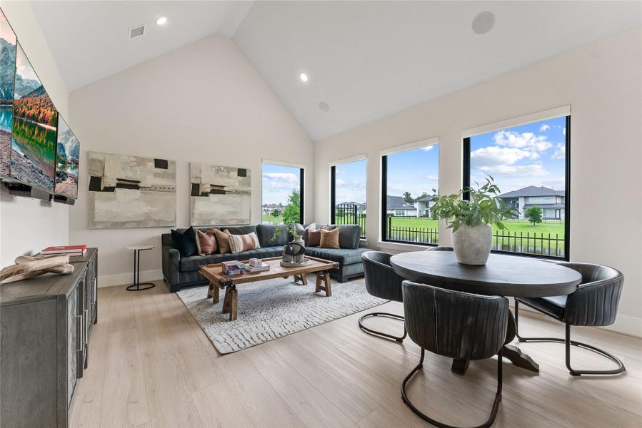 The downstairs game room provides a flexible gathering area with vaulted ceilings, backyard views, and direct access to the home’s shared living spaces. It is ideal for play, lounging, or casual entertaining without moving upstairs.