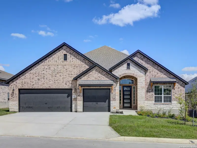 Front exterior of a new home in The Reserve at Potranco Oaks, Castroville, TX, highlighting curb appeal (Image 2).