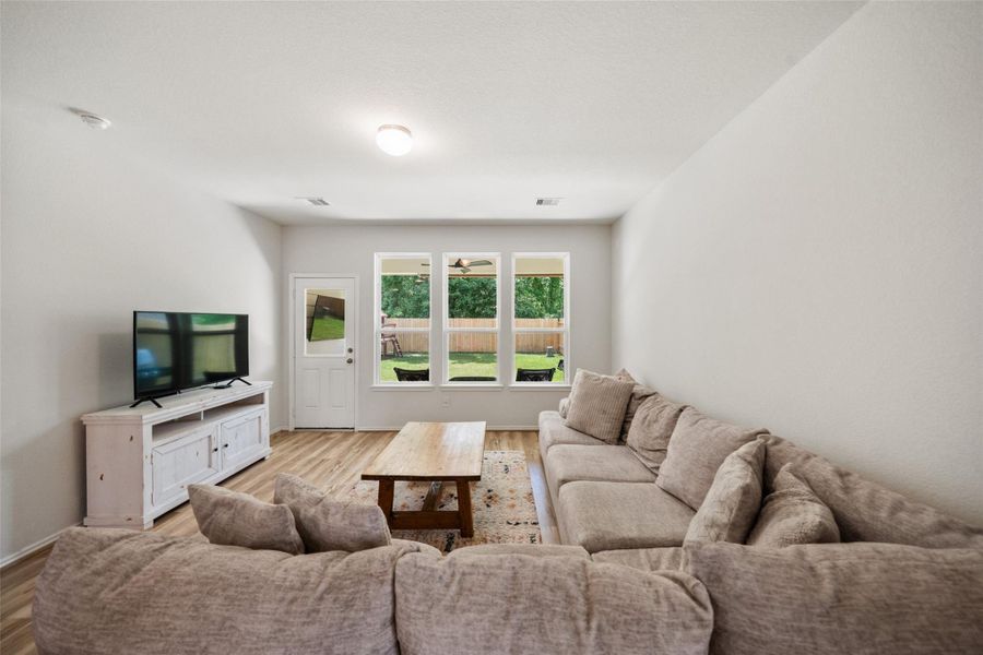 Living area gives you a view of the private backyard