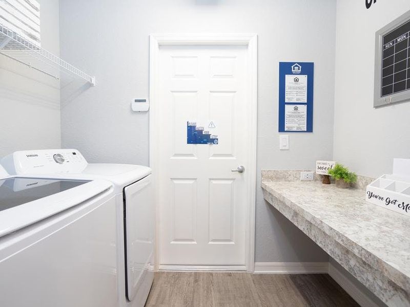 A laundry room with a convenient drop zone is located at the garage entry.