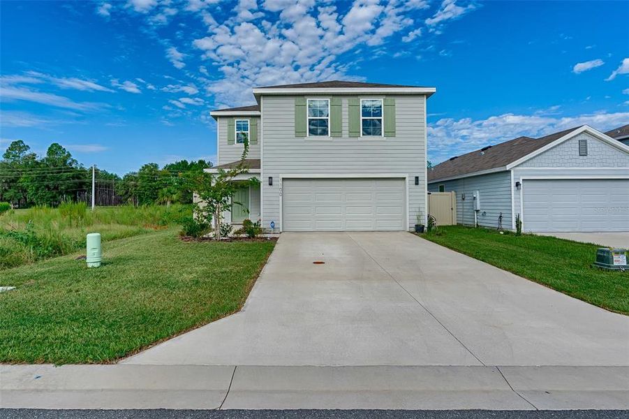 Front exterior of a new home in Avalon Woods, Newberry, FL, highlighting curb appeal (Image 22). Front exterior of a new home in Avalon Woods, Newberry, FL, highlighting curb appeal (Image 22).