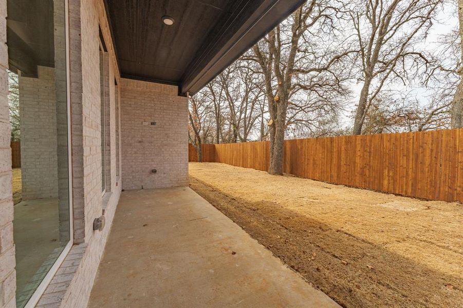 Fenced backyard with a patio