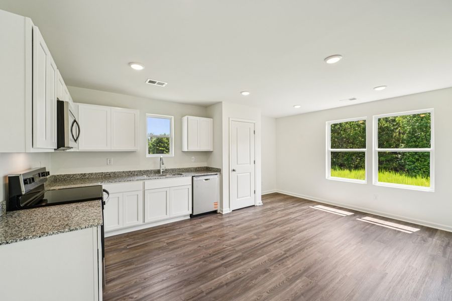 A kitchen with white cabinets. A kitchen with white cabinets.