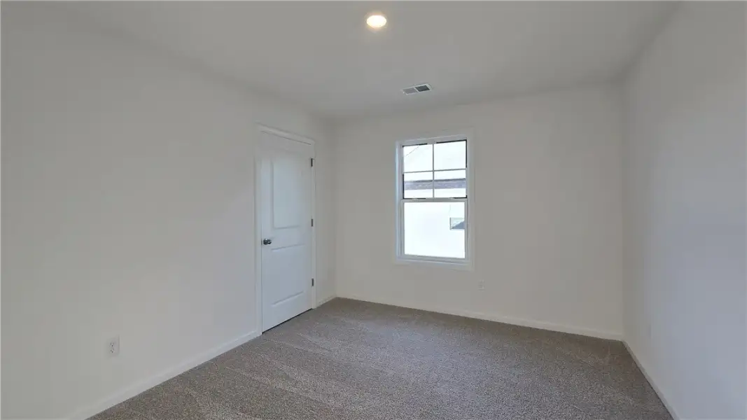 Plush carpeting and a classic sash window define t