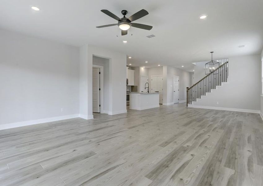 Open layout with the living room connecting to the dining area and kitchen.