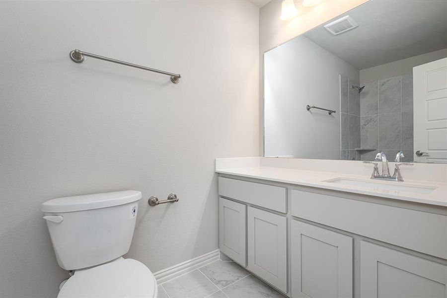 Bathroom featuring vanity and toilet