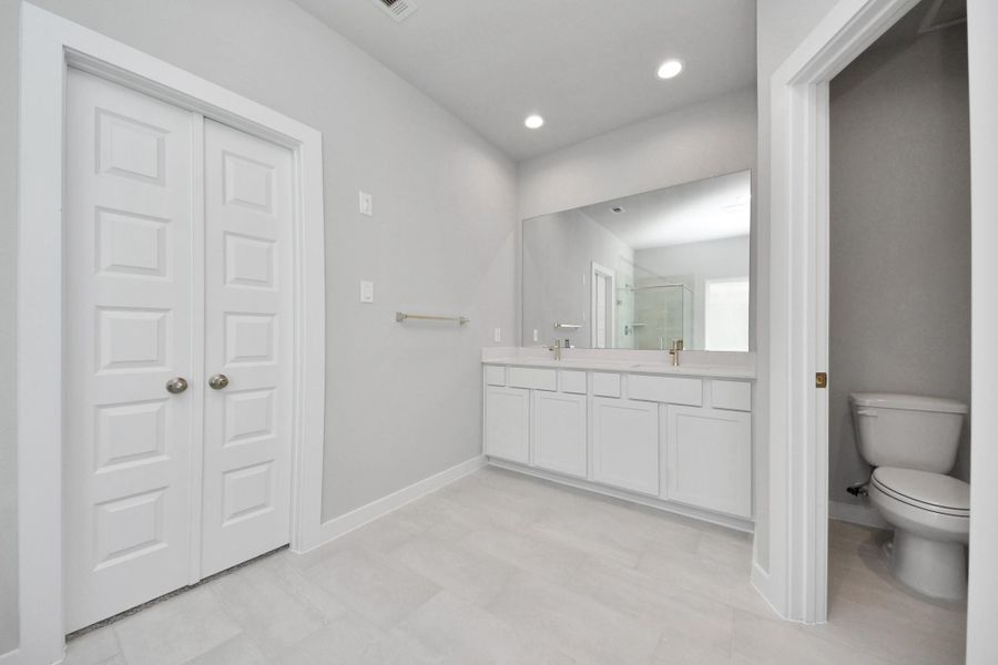 Elevate your daily routine at the elegant vanity, now equipped with double sinks, light countertops, modern hardware, and beautiful recessed lights. Sample photo of completed home with similar floor plan. Actual colors and selections may vary. Elevate your daily routine at the elegant vanity, now equipped with double sinks, light countertops, modern hardware, and beautiful recessed lights. Sample photo of completed home with similar floor plan. Actual colors and selections may vary.