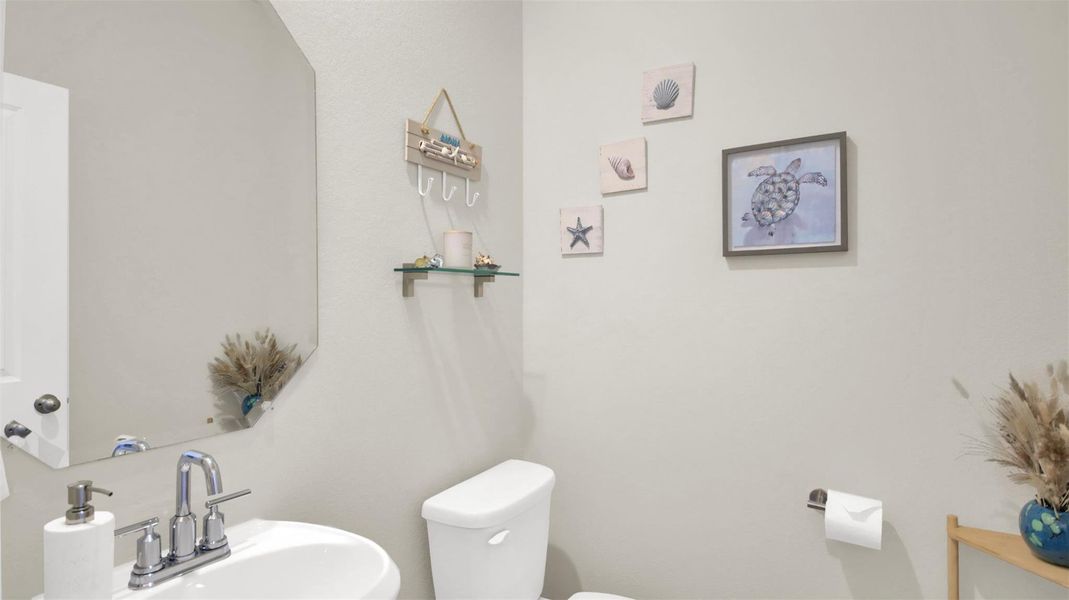 Powder room/ half bath with pedestal sink.