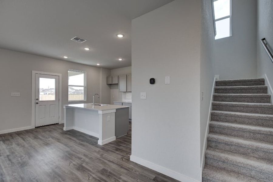 A room with a staircase and a counter. A room with a staircase and a counter.