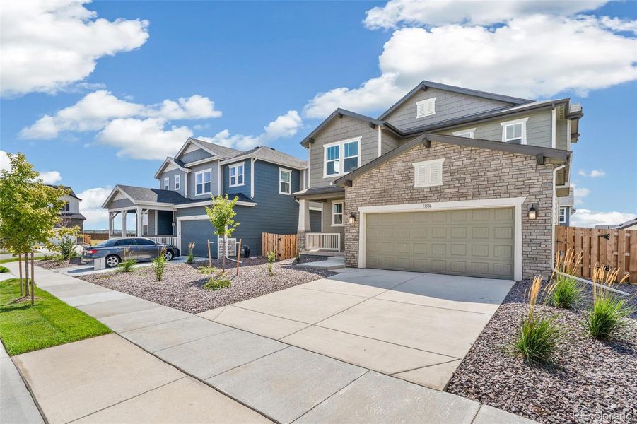 Front exterior of a new home in Turnberry, Commerce City, CO, highlighting curb appeal (Image 22).