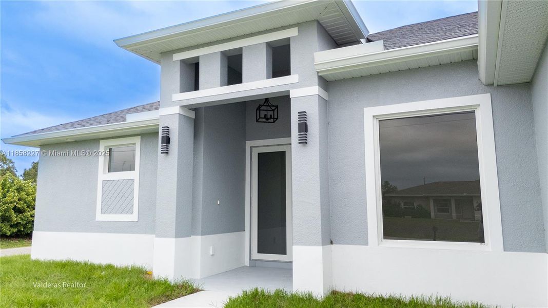 Front exterior of a new home in , Lehigh Acres, FL, highlighting curb appeal (Image 23).