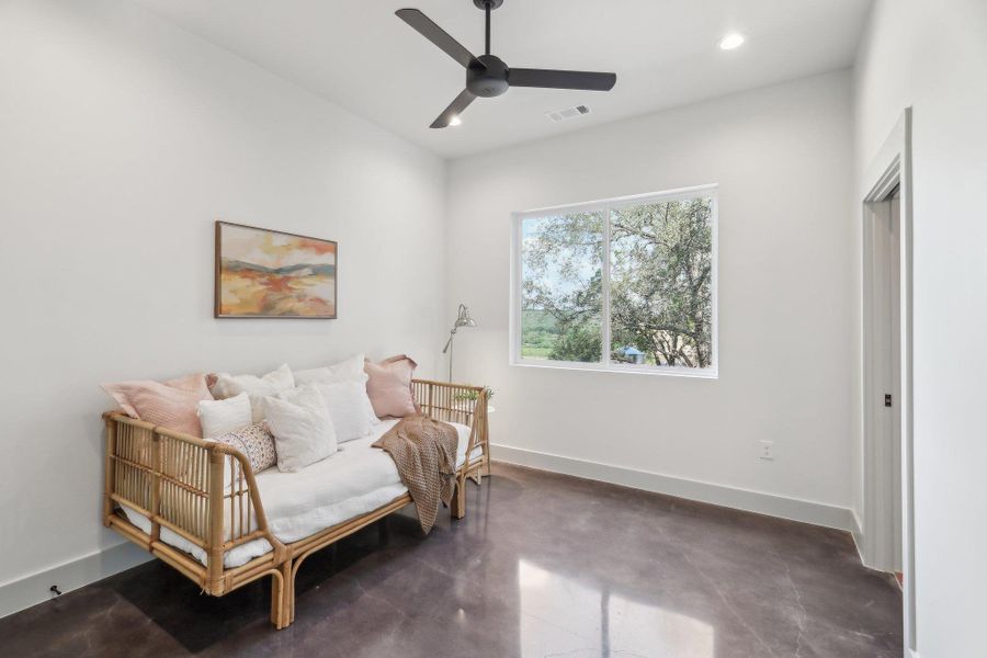 Living area with a ceiling fan, concrete floors, baseboards, and recessed lighting Living area with a ceiling fan, concrete floors, baseboards, and recessed lighting